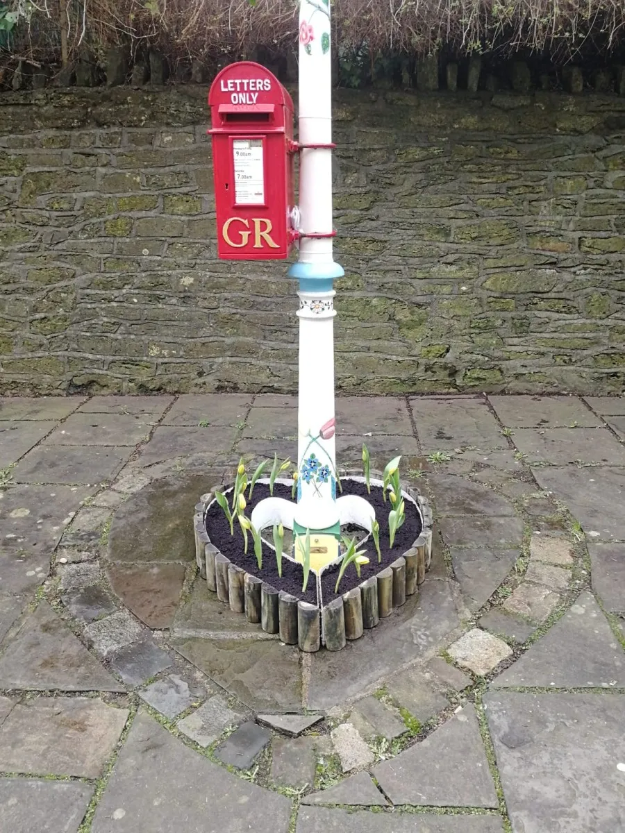 A Royal Mail King George V post box from the 1930s is attached to the lamp